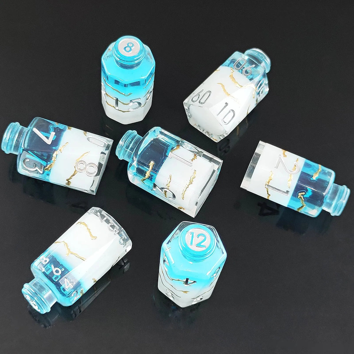 A set of seven floral resin potion bottles shaped like polyhedral dice, featuring various numbers and designs.