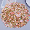 A pile of assorted gold and rose gold metal pendants and charms for jewelry making