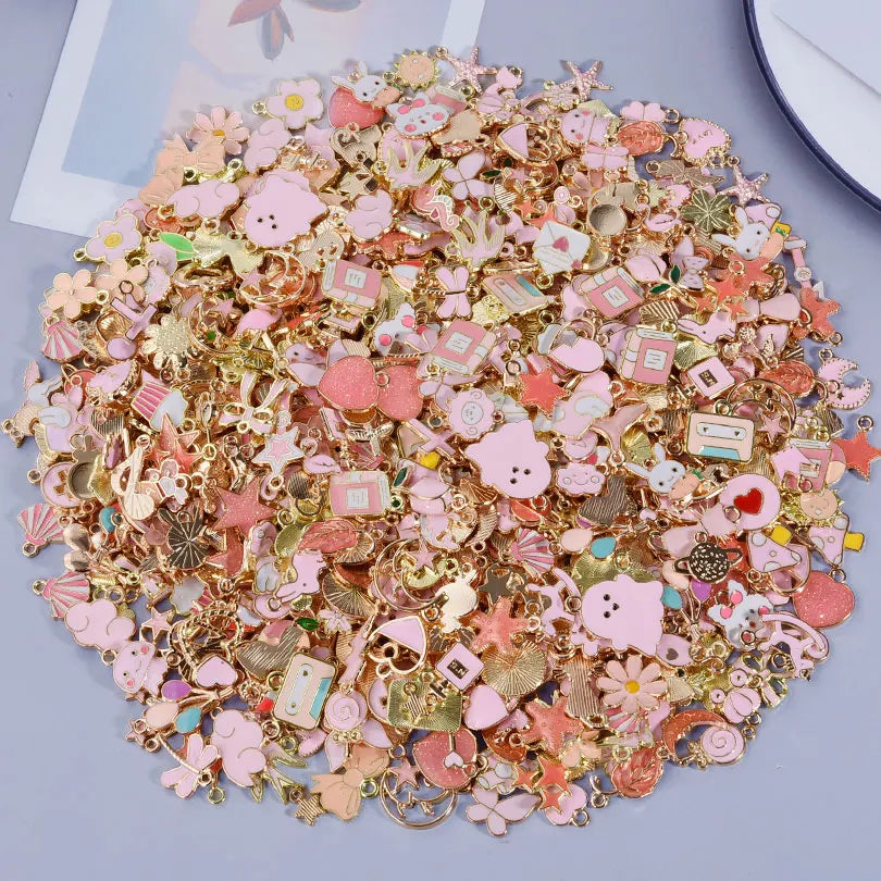 A pile of assorted gold and rose gold metal pendants and charms for jewelry making