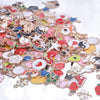 A close-up view of a large assortment of gold-tone enamel charms and beads for jewelry making
