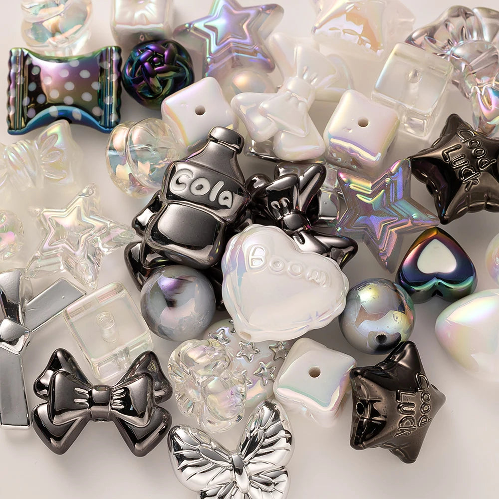 A collection of iridescent and clear acrylic bow and flower beads in various shapes and colors for DIY jewelry making