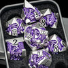 A set of silver and purple dragon-themed metal dice resting in a dark container.