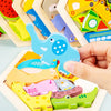 A hand places a blue elephant wooden jigsaw puzzle among other colorful animal puzzles.