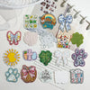 A collection of colorful glitter acrylic flatback resin cabochons shaped like flowers, animals, and seasonal themes for DIY c