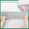 Stainless steel cross ruler used for diamond painting, showing a grid pattern and a paint dropper.