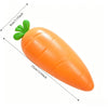 An orange squishy toy shaped like a carrot with green leaves, shown in profile.
