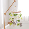 Wooden felt forest animal crib mobile featuring various animals like a giraffe and elephant hanging from a wooden rod.
