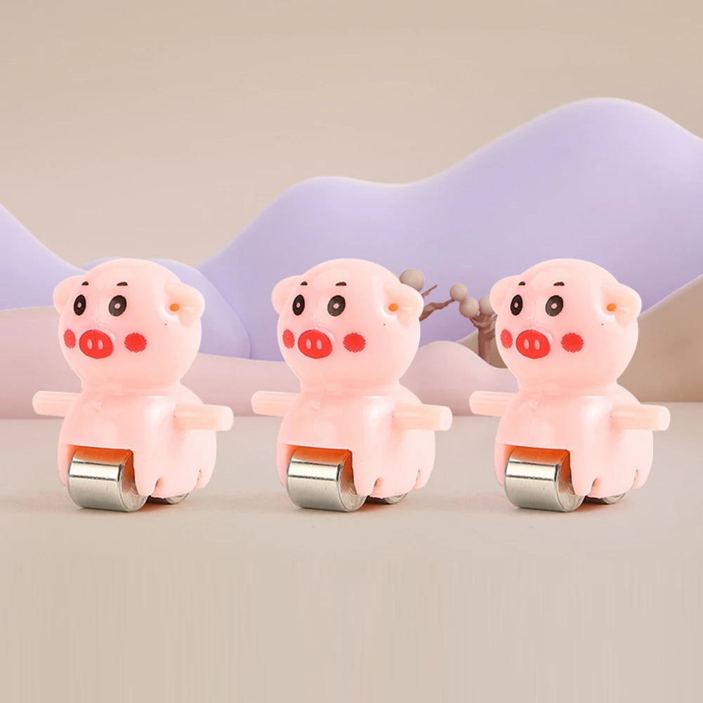 Three pink pig-shaped toy cars with silver tracks and slides set against a light background.