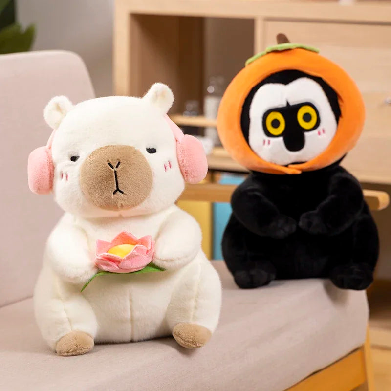 A white capybara plush toy holding a pink lotus flower next to an orange and black panda plush toy.