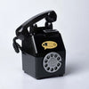 A black vintage rotary telephone piggy bank with a coiled cord and a keypad.