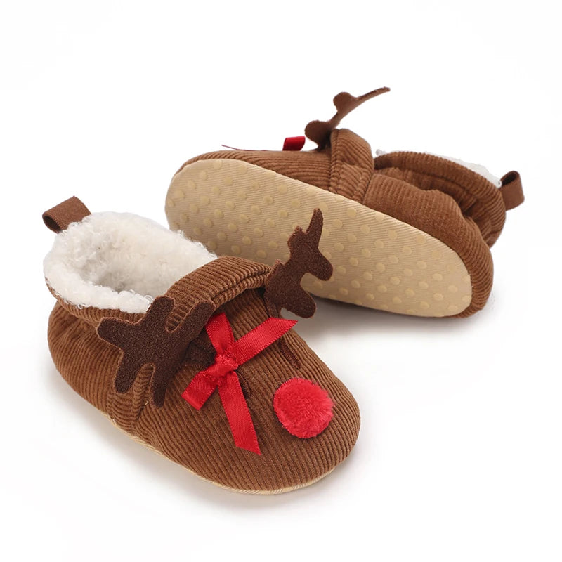 A pair of brown animal-themed baby first walker shoes with faux fur trim and decorative antlers.