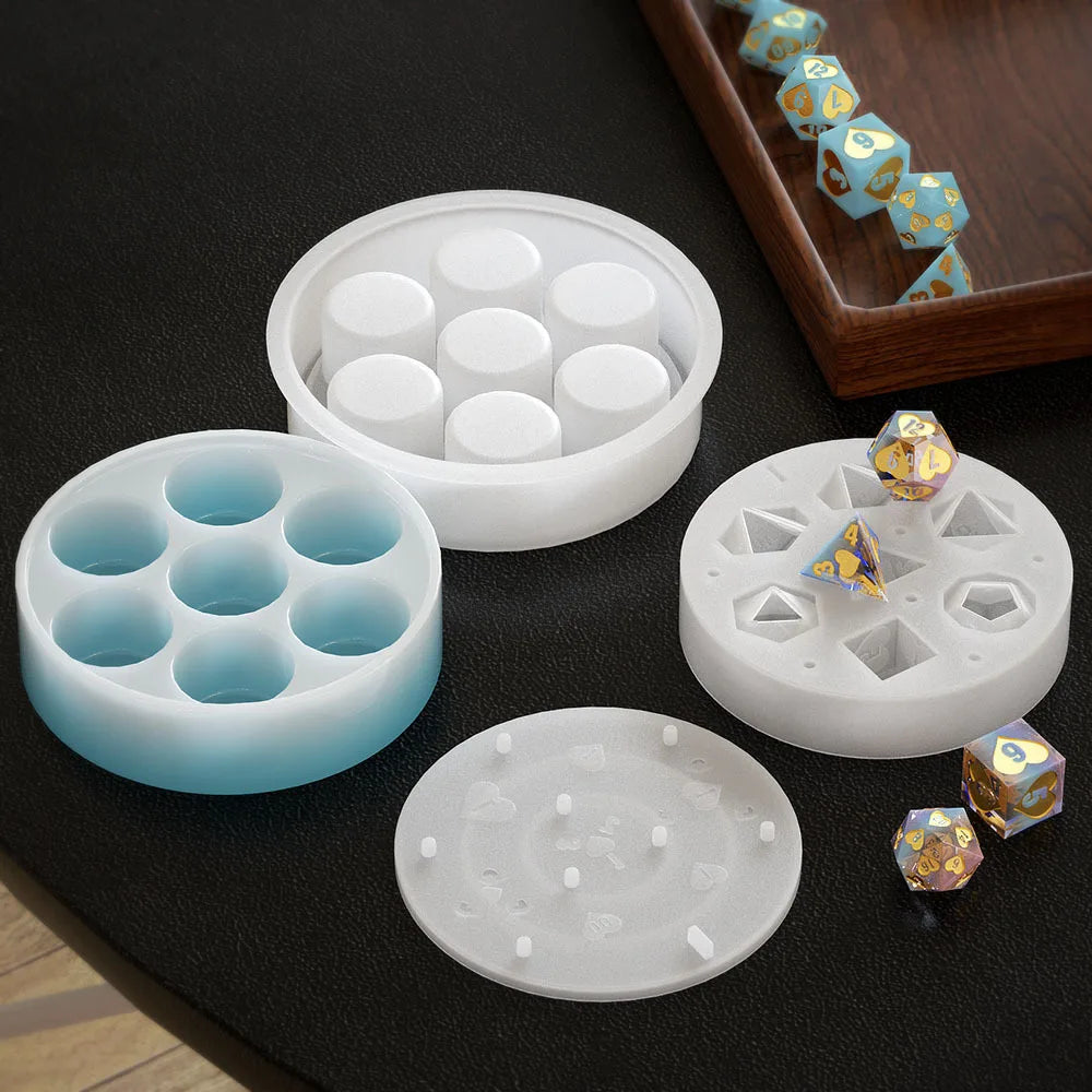 A set of white silicone resin molds for creating custom dice boxes and shapes, including various hexagonal and round pieces.