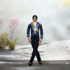 A plush doll resembling Michael Jackson in a blue and gold outfit standing against a white background.