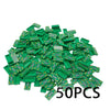 A pile of green building blocks shaped like treasure chests with gold and silver coins.