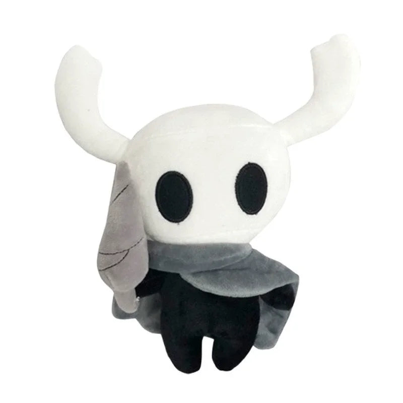A white plush doll resembling the character Hollow Knight from Silksong, featuring large ears and a dark cape.