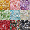 A collection of colorful glass beads in various shades including pink, green, yellow, purple, and clear tones.