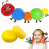 A set of colorful soft dense paint sponges in red, blue, orange, and green are shown next to a smiling girl.