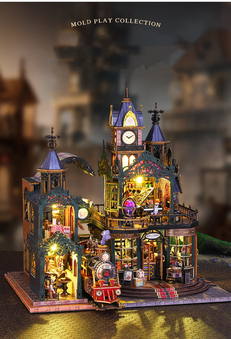 A detailed wooden miniature rail-track city dollhouse kit featuring buildings, shops, and figures.