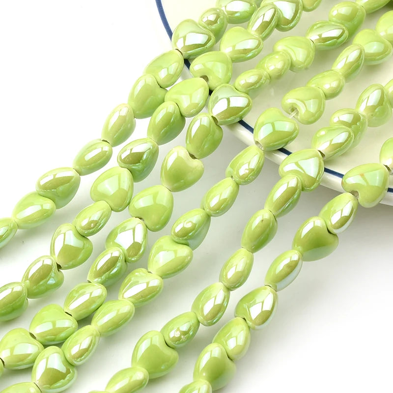 A string of light green heart-shaped acrylic beads for jewelry making