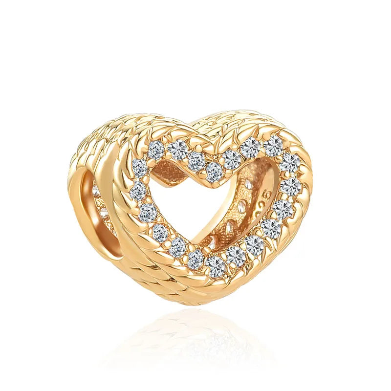Gold charm bracelet featuring heart-shaped pendants with elephant, key, butterfly, and heart designs