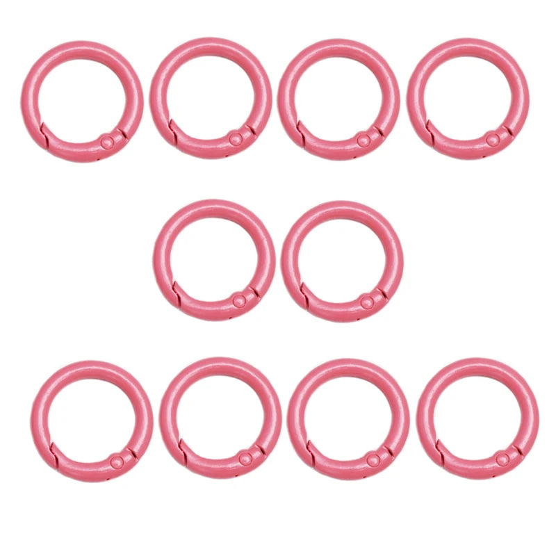 A set of eight pink alloy snap hook keychain clips arranged in two rows.