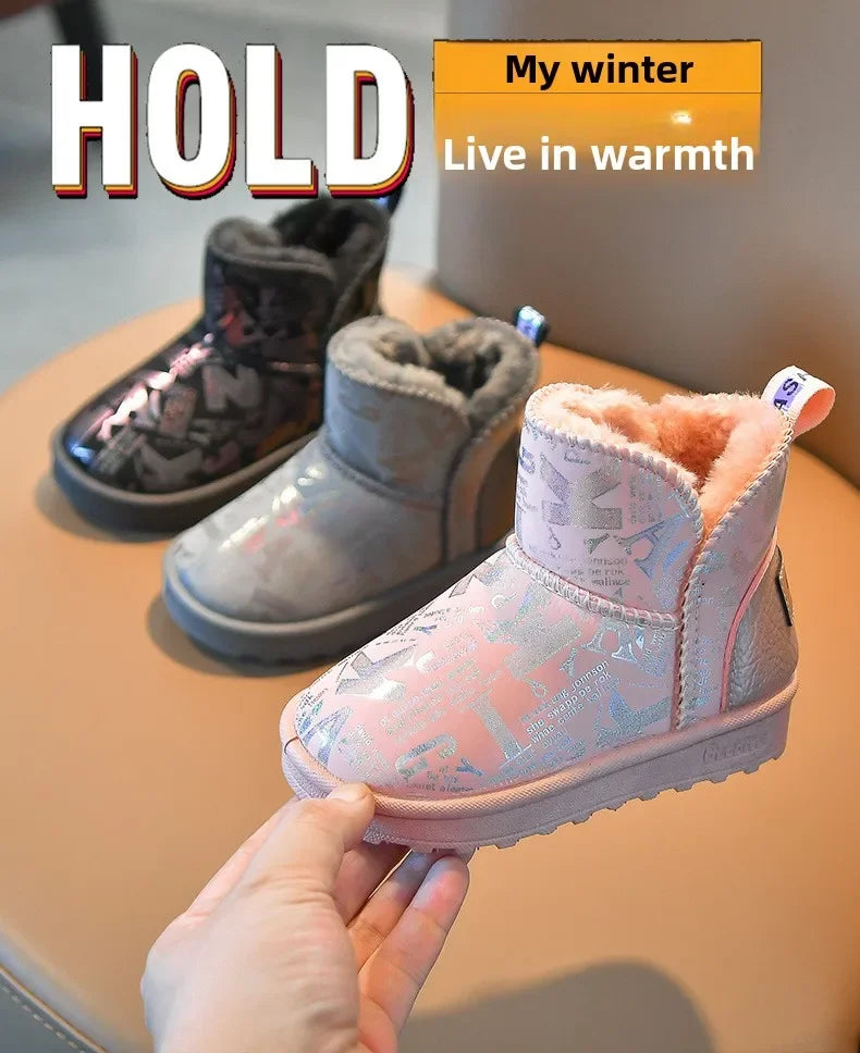 A hand holds a pink winter snow boot with a fluffy faux fur lining and a non-slip sole.
