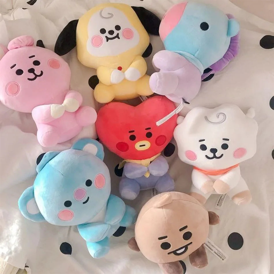 A collection of pastel-colored kawaii anime mini plush keychains featuring characters like a pink bear, yellow bear, and blue