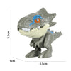 A gray finger dinosaur fidget toy with movable joints featuring an orange eye and white teeth.