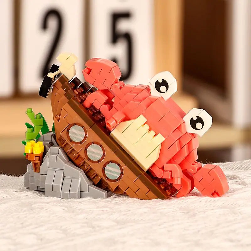 A set of building blocks shaped like a shark, crab, and clownfish in orange and red colors.