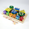 A set of colorful wooden blocks shaped like fish in geometric patterns used for an early learning puzzle game.