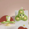A green suction cup spinner bath toy shaped like a crocodile is displayed on a white surface.