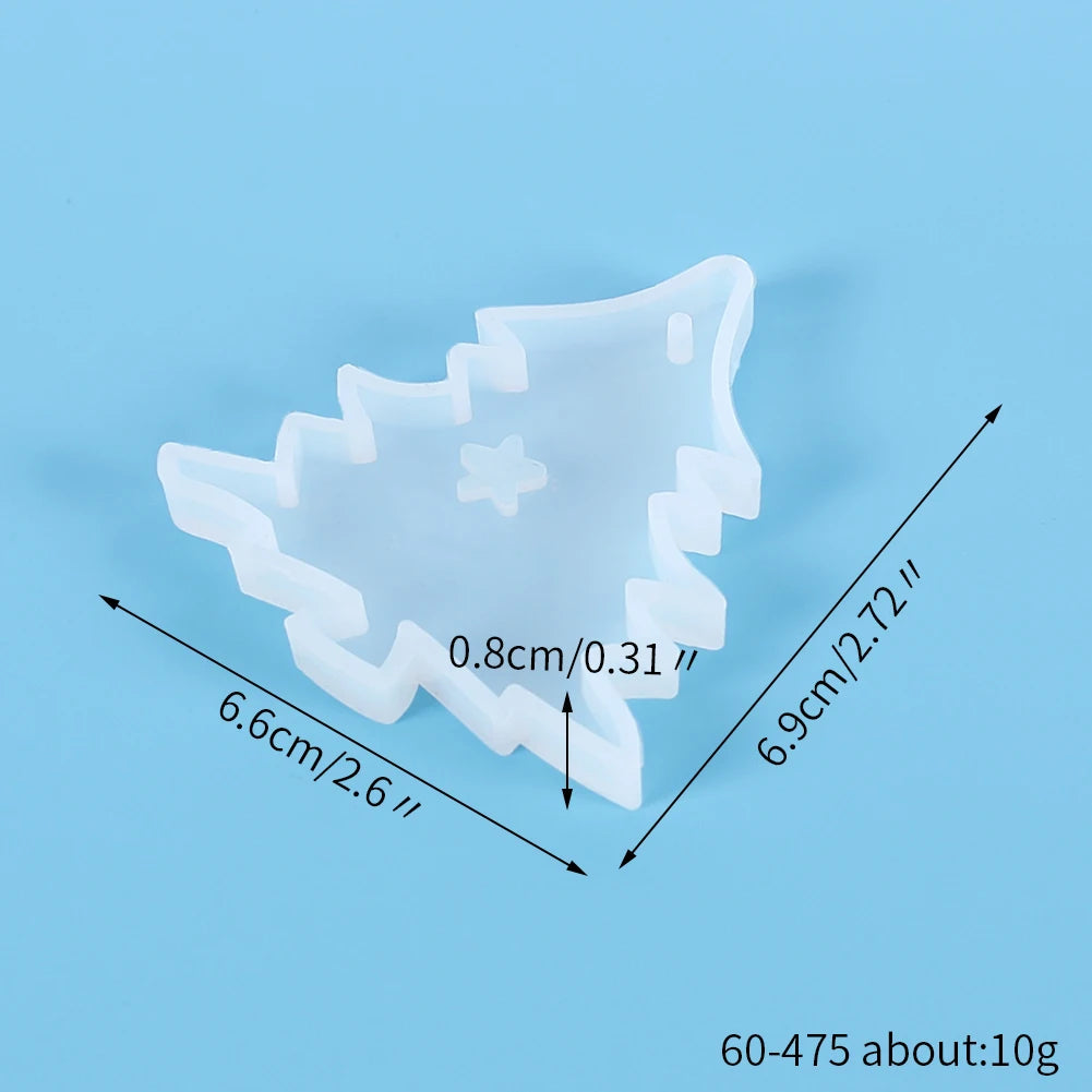 A white silicone mold shaped like a Christmas tree, used for jewelry and craft projects.