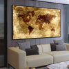 A living room scene featuring a large framed map of the world above a beige sofa.