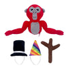 A red and gray plush toy of a monke with large eyes, next to a black top hat and a brown tree branch.