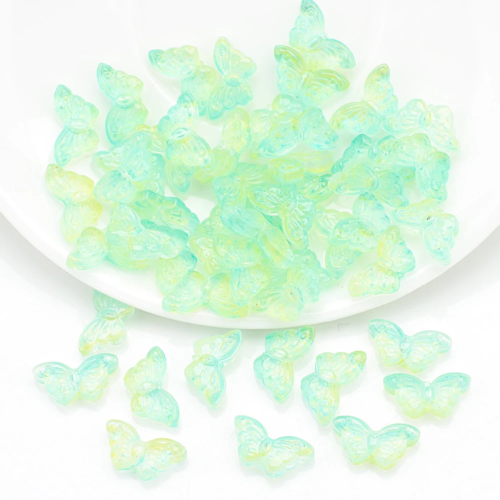 A pile of light green butterfly glass beads for jewelry making