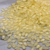 A pile of translucent yellow water drop Czech glass beads for jewelry making