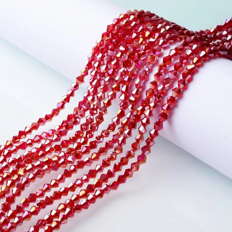 A close-up of red faceted glass crystal beads strung together, showcasing their vibrant color and cut.