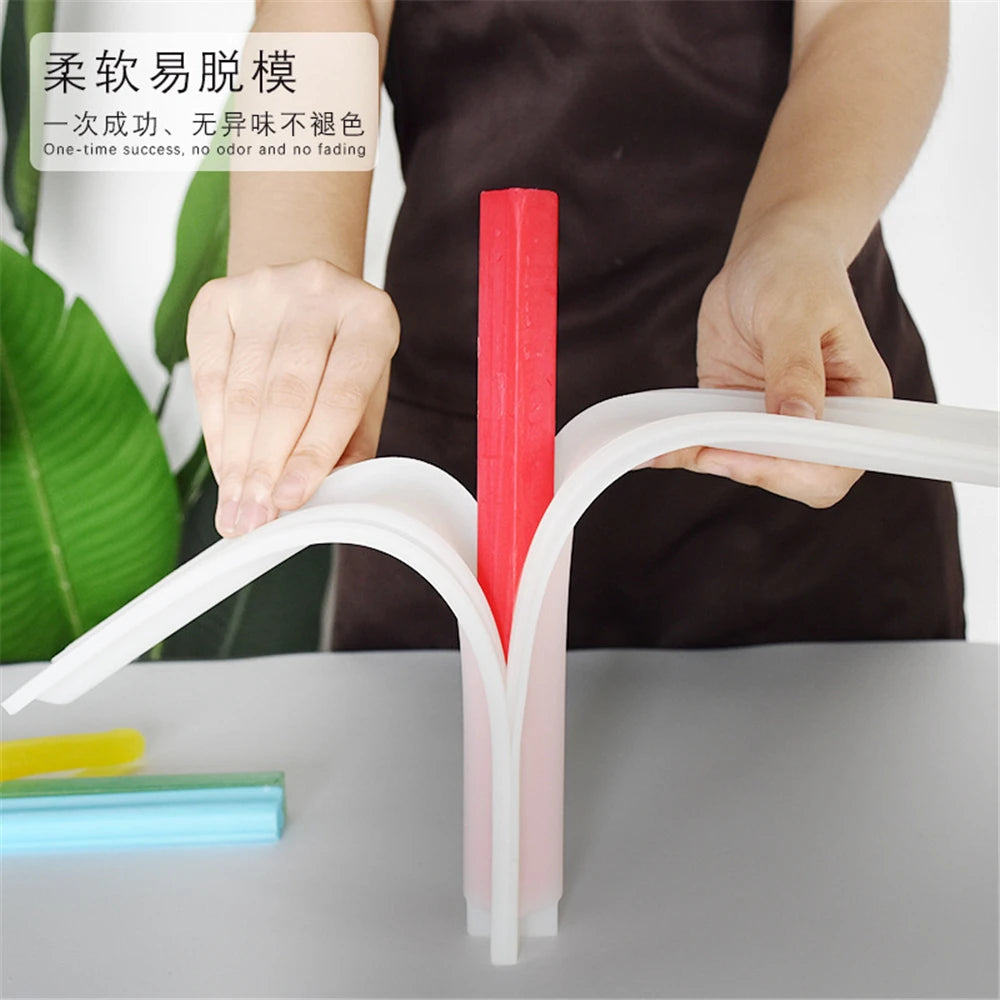 A hand is holding a pink silicone mold with a red insert, demonstrating the one-time success of the mold.