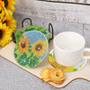 A set of five mandala flower 5D diamond painting coasters with black handles displayed on a light wooden surface.