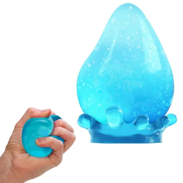 A hand holds a translucent blue sensory stress relief therapy ball shaped like a teardrop.