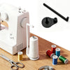 A white vertical sewing machine with a spool holder and thread guide, along with several spools of thread.