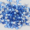 A pile of blue and silver glass crystal flatback rhinestones for nail art and crafts.