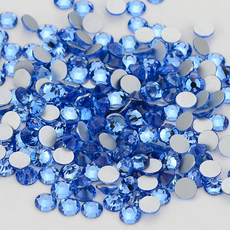 A pile of blue and silver glass crystal flatback rhinestones for nail art and crafts.