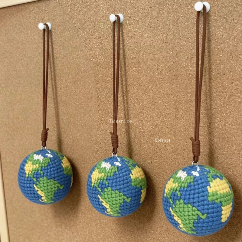 Handcrafted crochet earth keychain charm featuring a globe design with blue and green colors.