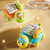 A multicolor turtle-shaped toy resembling a phone, featuring bright green and orange colors on a wooden floor.