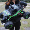 A person holds a black and green high-speed 4WD off-road RC truck with large tires and LED lights.