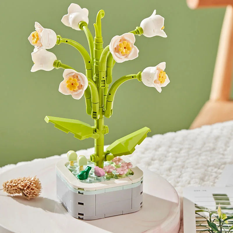 A green rose flower building block bouquet set with white and yellow flowers displayed on a white surface.