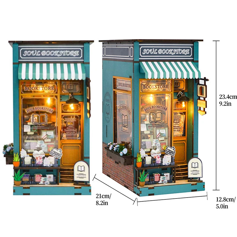 A wooden DIY book nook kit featuring a storefront display with miniature furniture and books.
