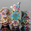 A set of seven iridescent metal dice, including a pyramid and various polyhedral shapes, reflecting on a dark surface.