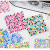 A collection of colorful star-shaped mini deco cut film stickers displayed on a white surface next to a measuring tool.